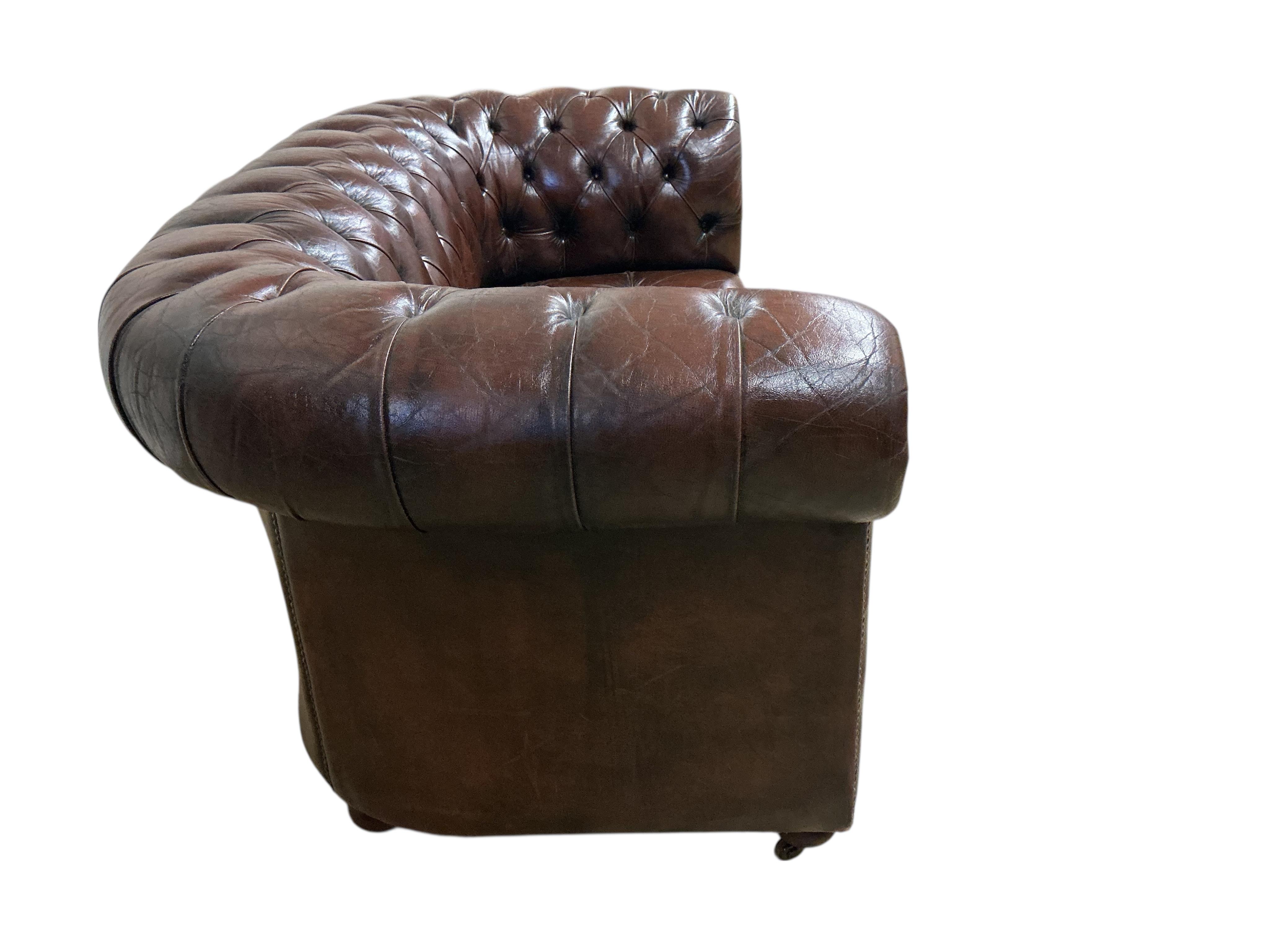 A Victorian style buttoned brown leather Chesterfield settee, width 170cm, depth 84cm, height 76cm